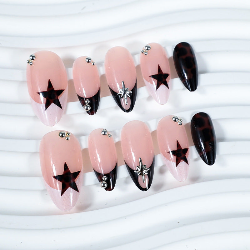 Acrylic nail set with creative star patterns and glitter accents Stornfield