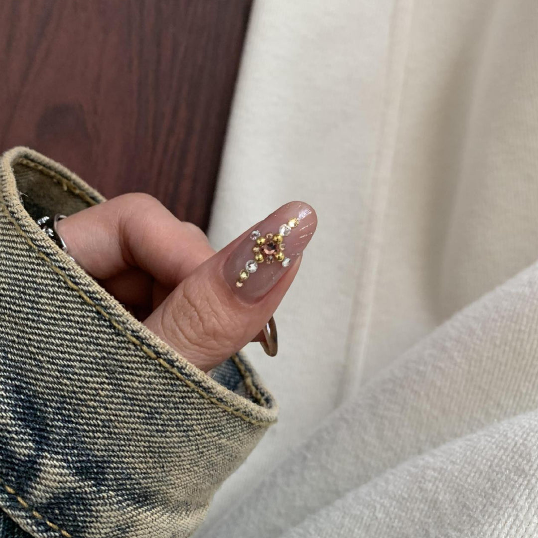 Artificial nail set with elegant patterns and glitter accents Stornfield