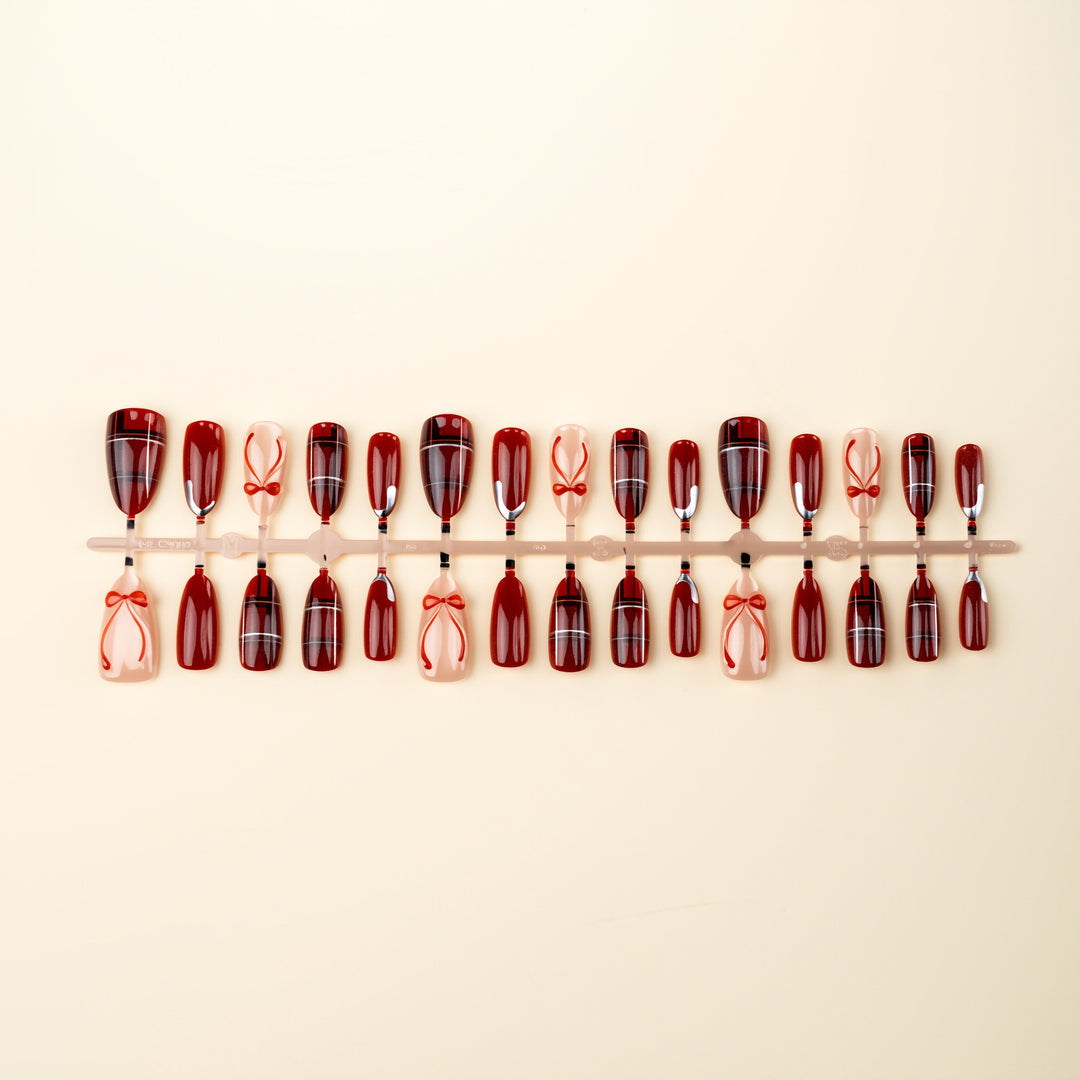 Art nail set with festive design and bow accents Stornfield