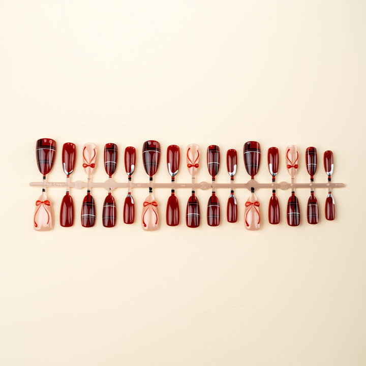 Art nail set with festive design and bow accents Stornfield