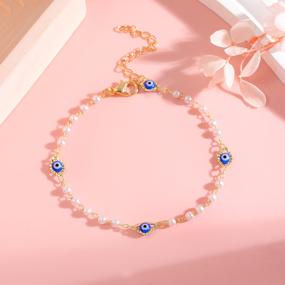 Elegant Pearl and Eye Charm Necklace Stornfield