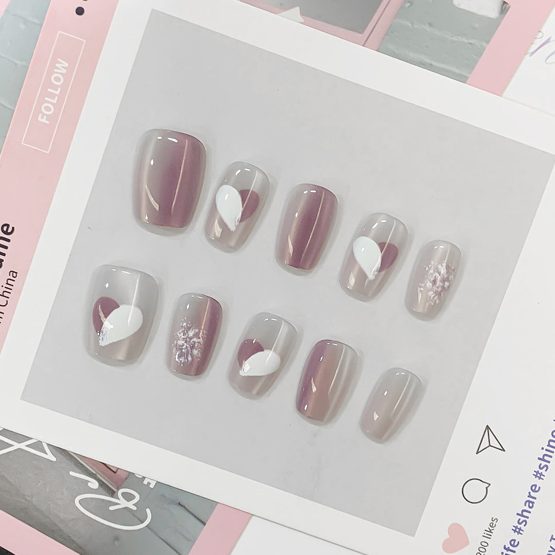 Artistic acrylic nails with heart-shaped accents Stornfield
