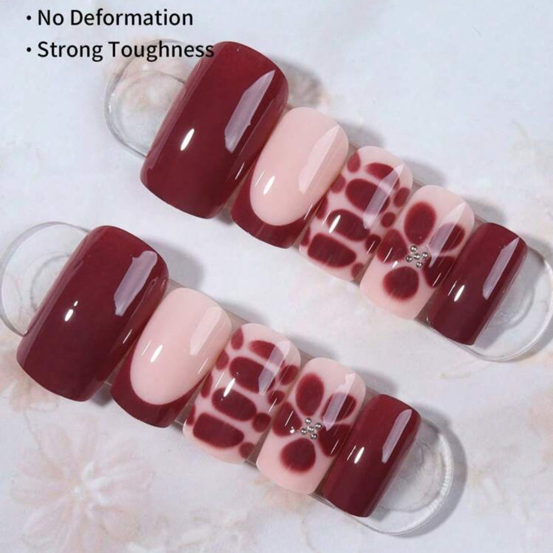 Artificial nail set with elegant geometric designs and accentuating rhinestone details Stornfield