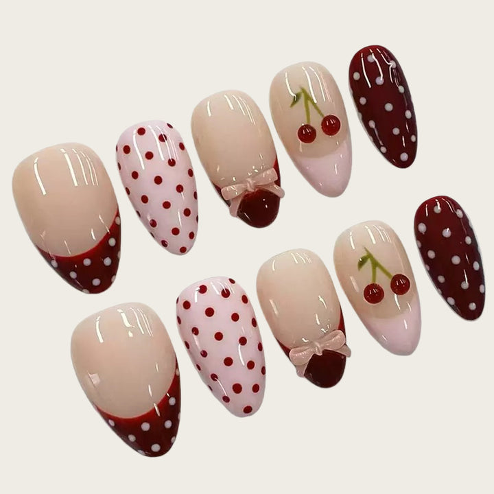 Artfully designed nail tips with cherry and dot motifs Stornfield