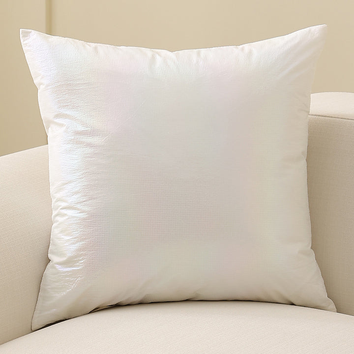 Square decorative cushion with delicate mother-of-pearl look and fine micro tuft structure