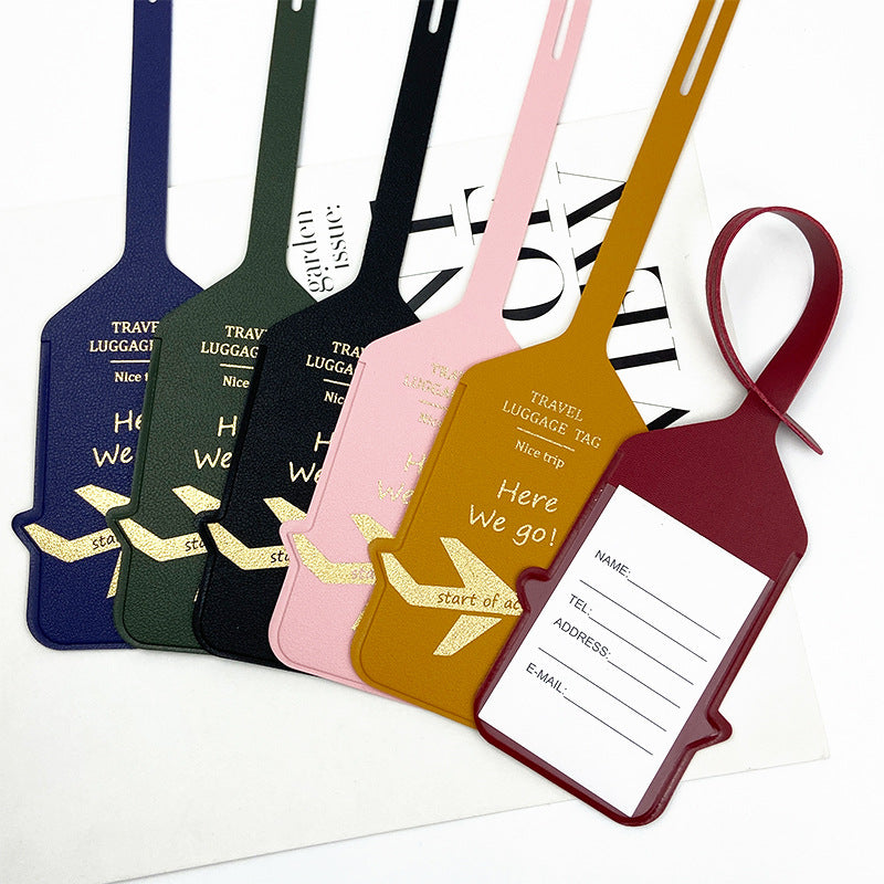 premium leather travel luggage ID tag with embossed airplane motif and adjustable strap Stornfield