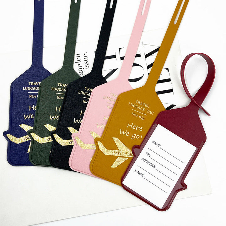 premium leather travel luggage ID tag with embossed airplane motif and adjustable strap Stornfield