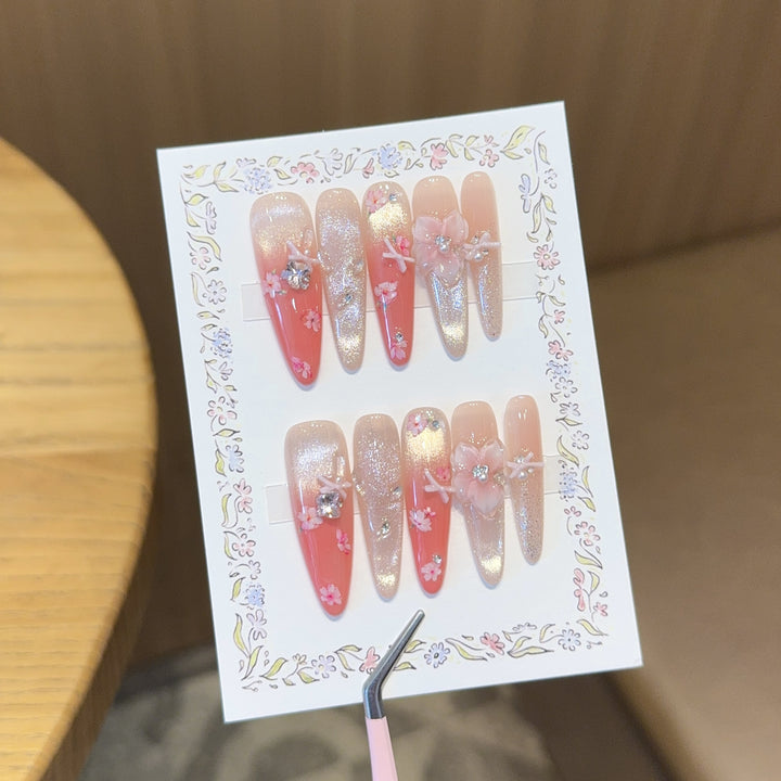 Artificial nails with floral embellishments and glitter effects Stornfield