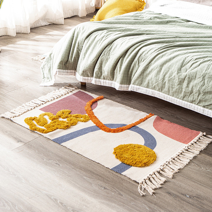 Hand-tufted bathroom mat with fringes, decorative dot-and-dash pattern and non-slip backing Stornfield
