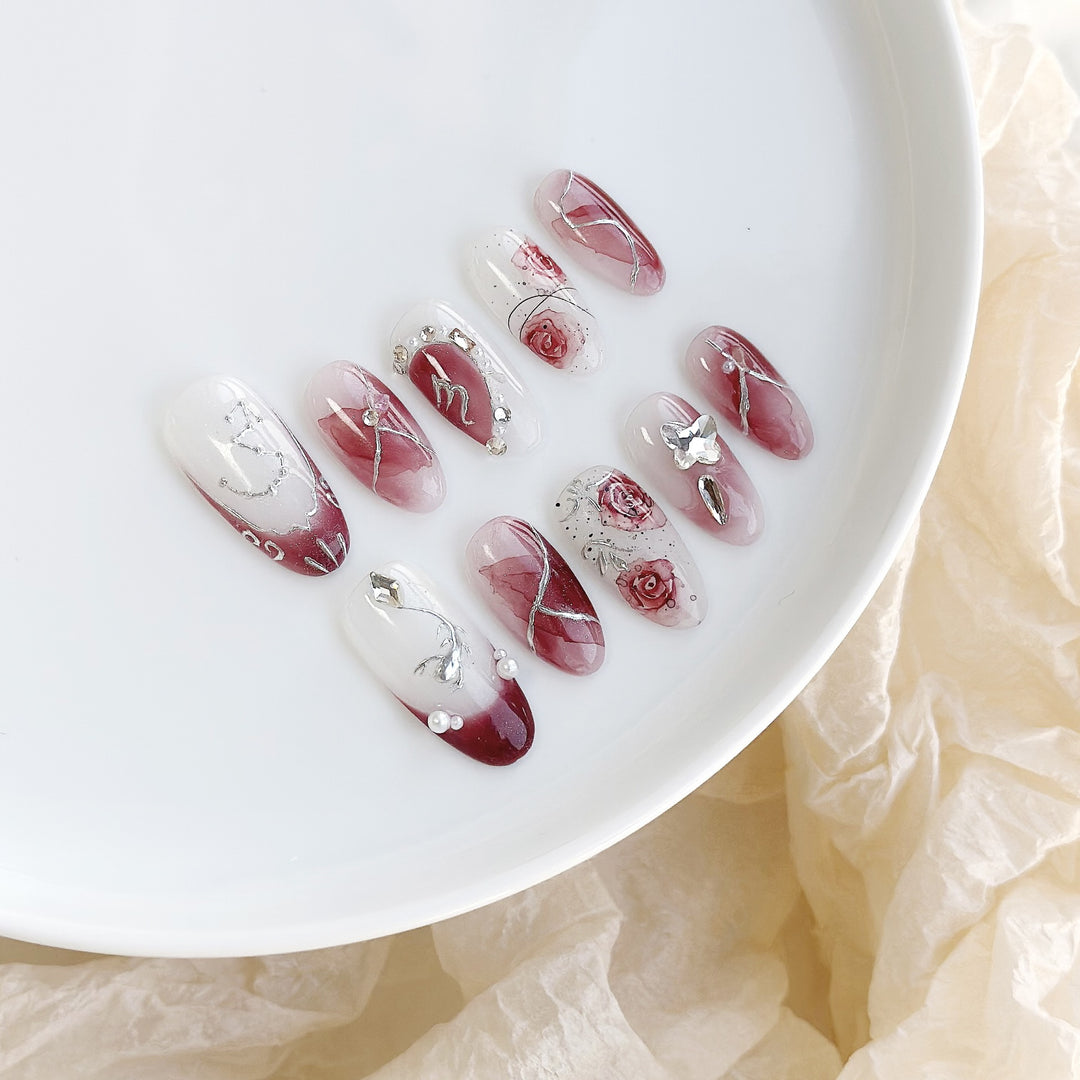 Artistic Press-On Nail Set with Floral Designs and Gem Accents
