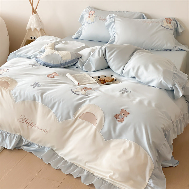 Playful satin bedding set with ruffled border, appliqués and quilted head section