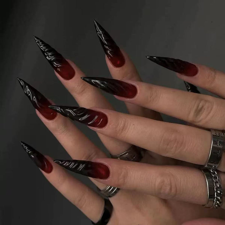 Gothic-style artificial nails with pointed tips and shiny surface Stornfield