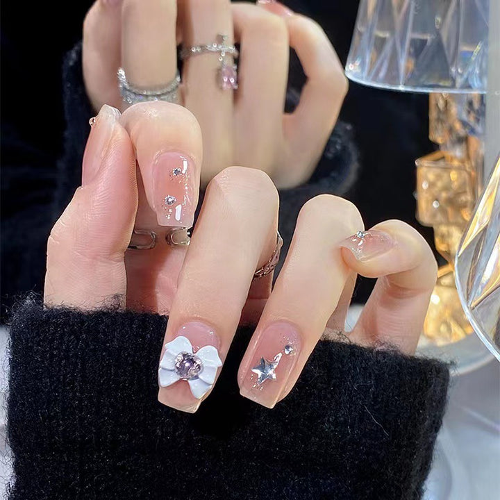 Artistic nail tips with floral and glittering accents Stornfield