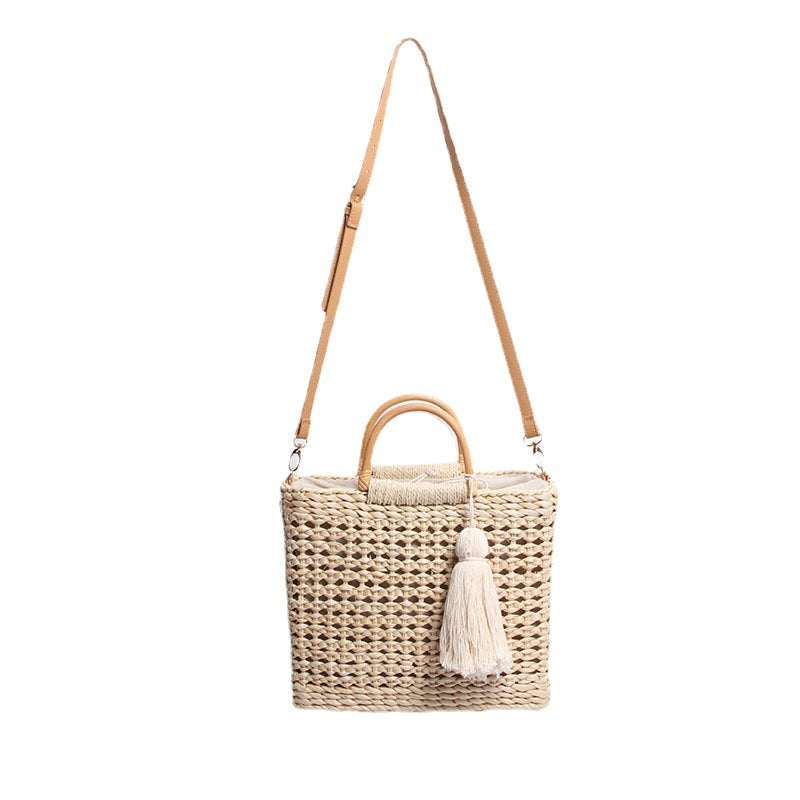 Handcrafted straw shoulder bag with decorative tassel pendant Stornfield