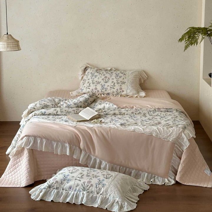 Romantic quilted bedspread and bedding set with ruffle and floral linen look
