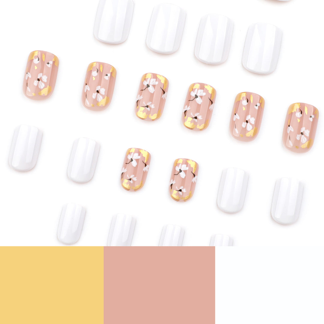 Artificial nail art with delicate flowers and glitter accents Stornfield