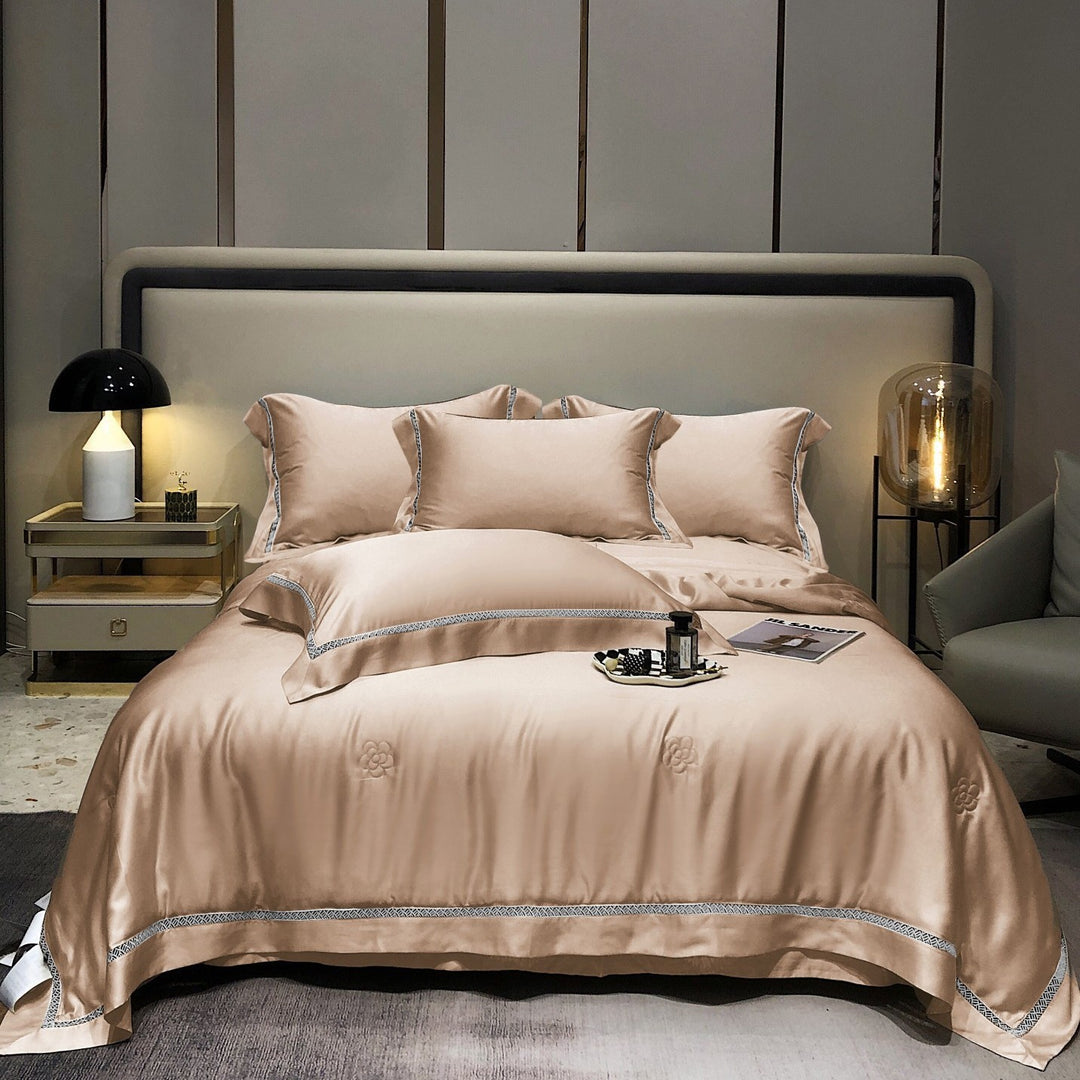 Luxurious satin bedding set with fine embroidered border and tone-on-tone floral relief