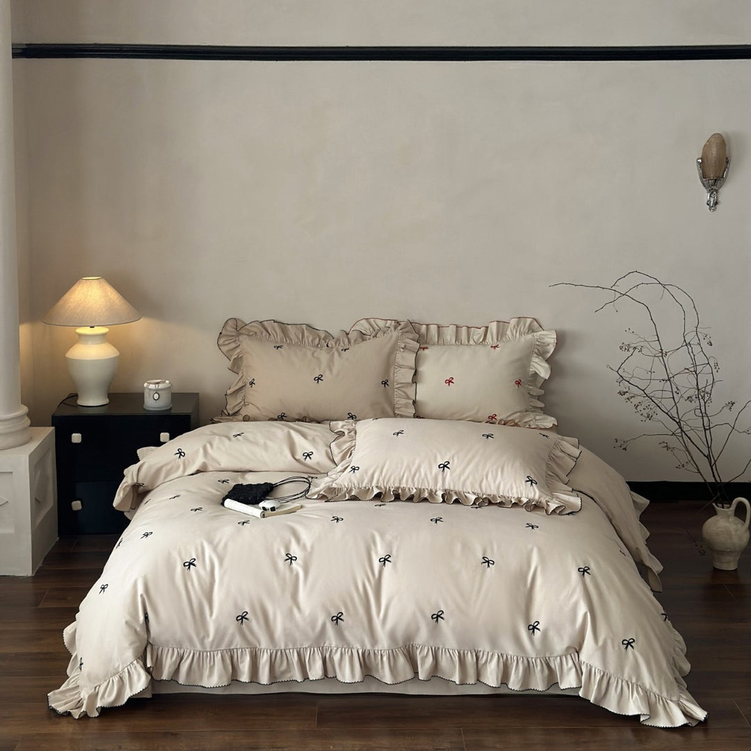 Ruffled bedding set with embroidered bows and frills