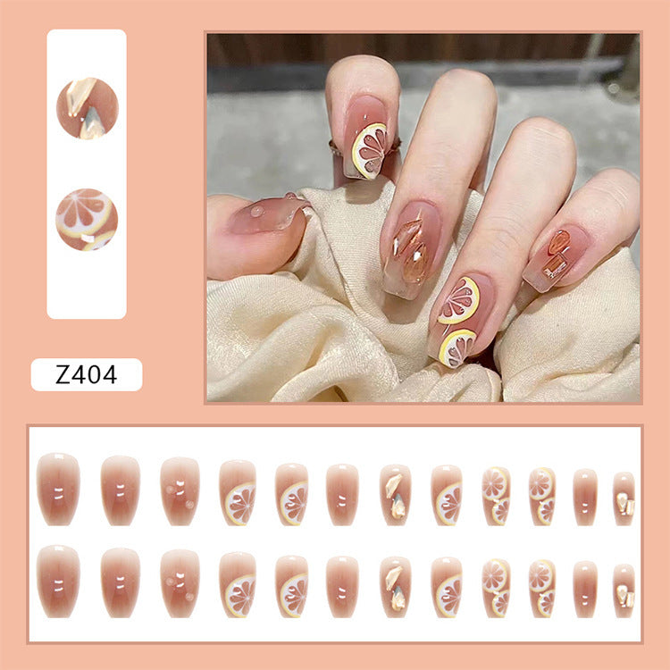 Artificial nail set with cheerful citrus motifs and elegant designs Stornfield