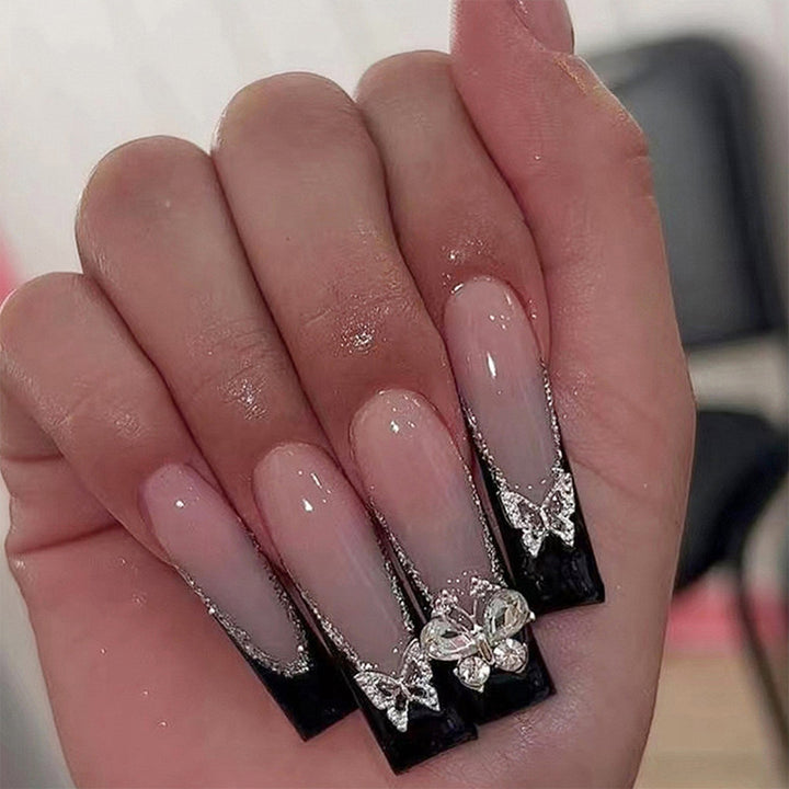 Glamorous artificial nails with rhinestone and butterfly elements Stornfield
