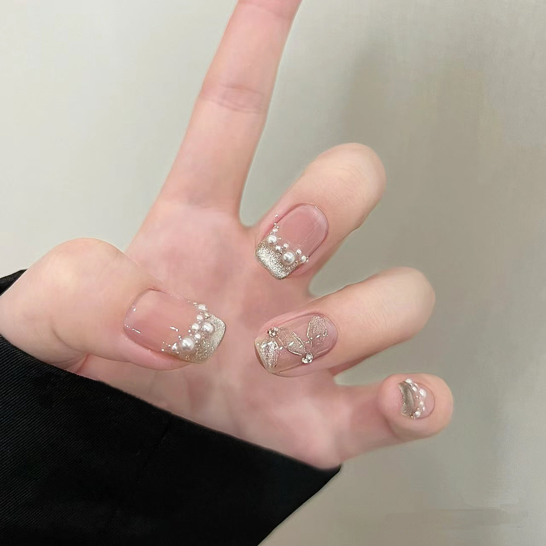 Elegant artificial nails with pearl decorations and glitter effects Stornfield