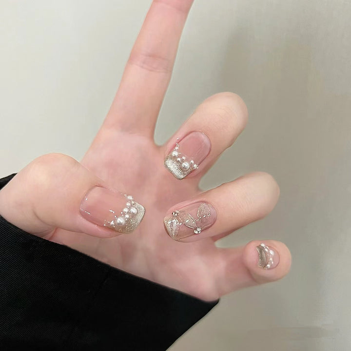 Elegant artificial nails with pearl decorations and glitter effects Stornfield