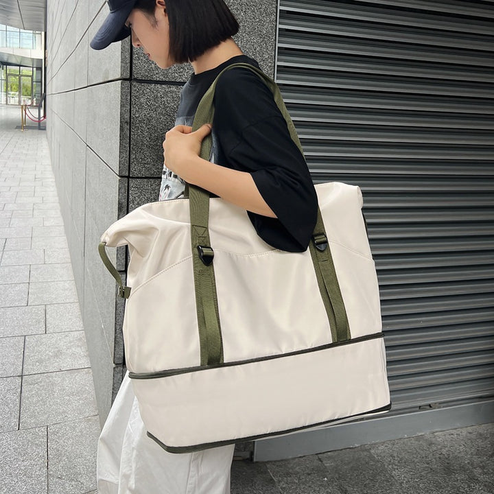 Sporty shoulder bag with water-repellent material and sturdy carrying handles Stornfield