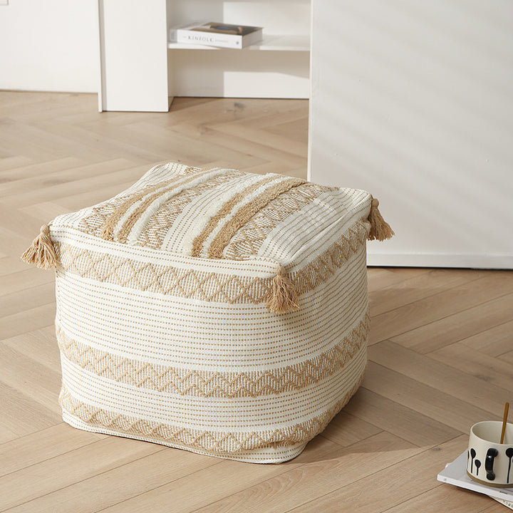 Braided square floor seat pouf with tassels and woven ethnic pattern