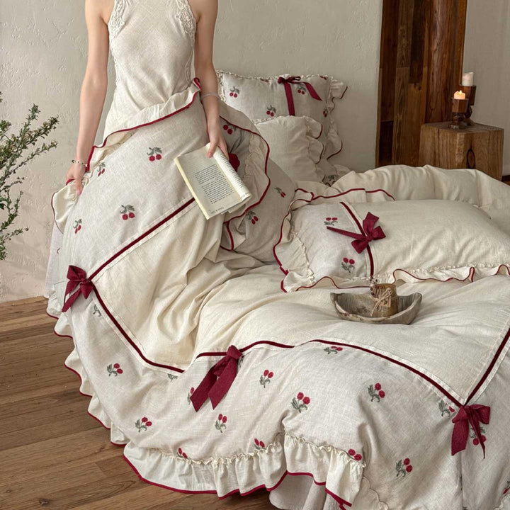 Country house bedding set made of linen-cotton blend with hand-embroidered cherry motifs, ruffles and decorative bows