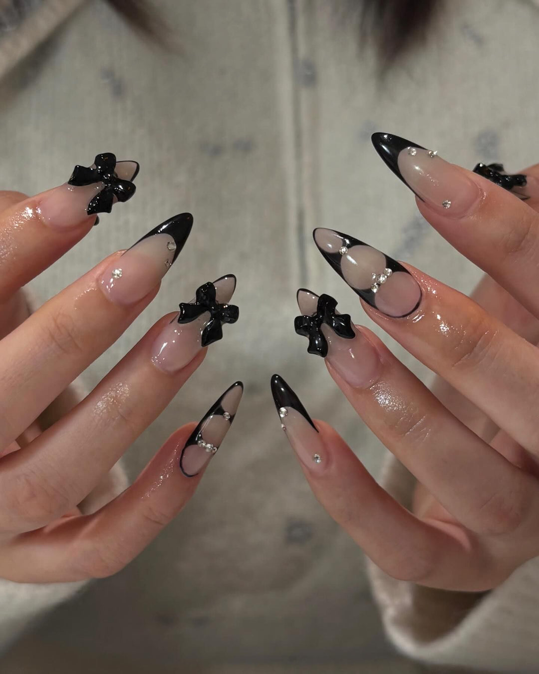Acrylic nail set with shimmering accents and elegant bows Stornfield