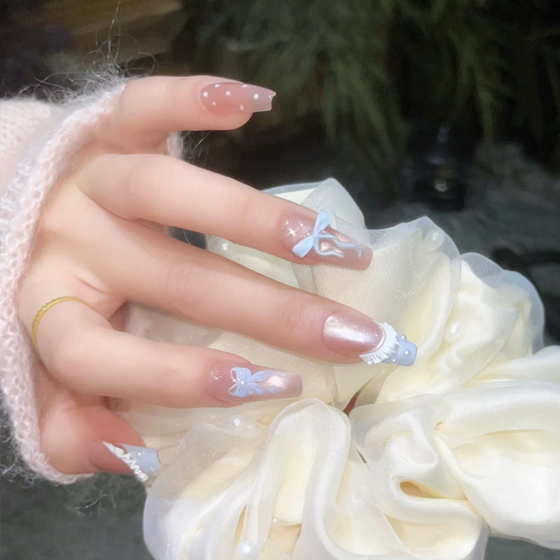 Art nail set with filigree bows and glitter accents Stornfield