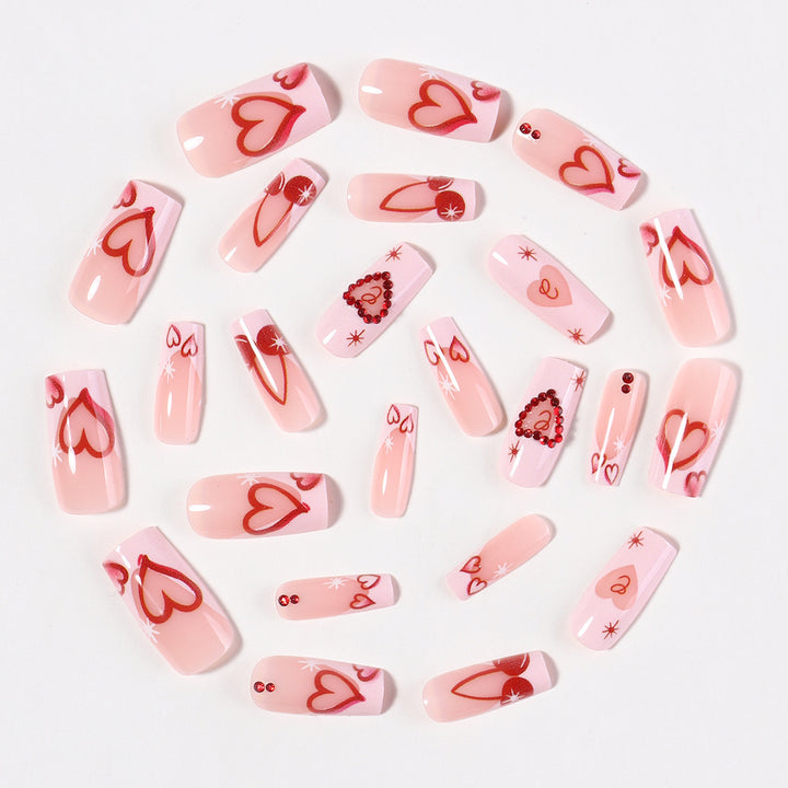 Artificial nail set with romantic heart designs and sparkling rhinestone decorations Stornfield