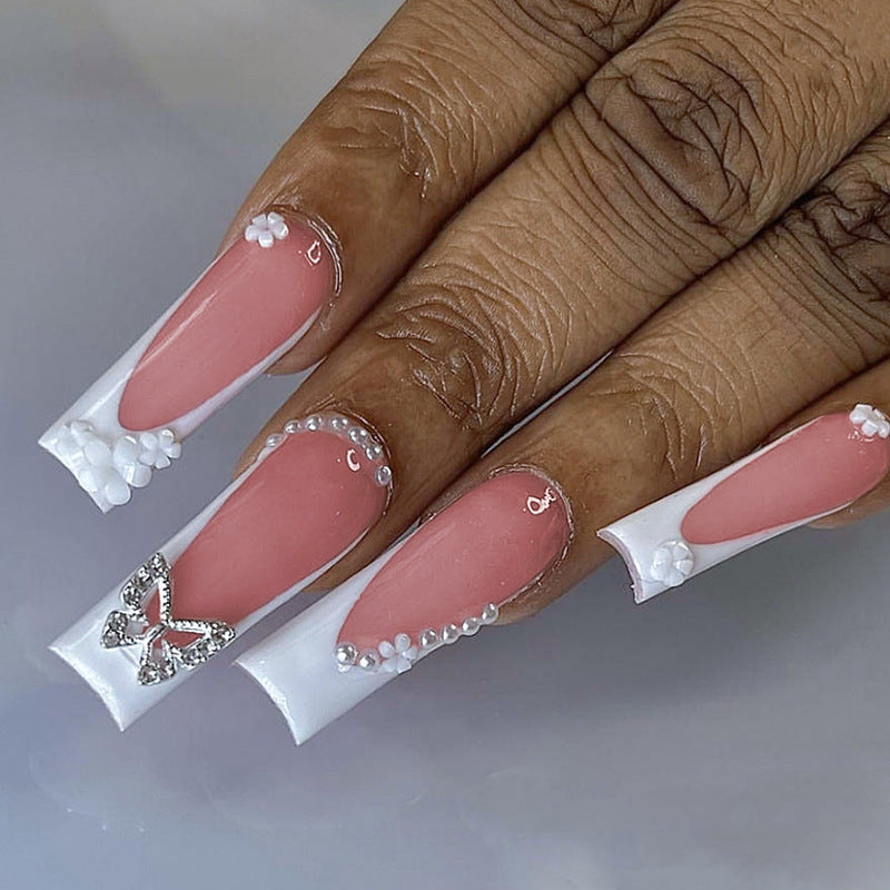 Artificial nail set with elegant floral decorations and glitter accents Stornfield