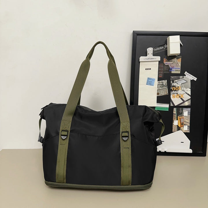 Sporty shoulder bag with water-repellent material and sturdy carrying handles Stornfield