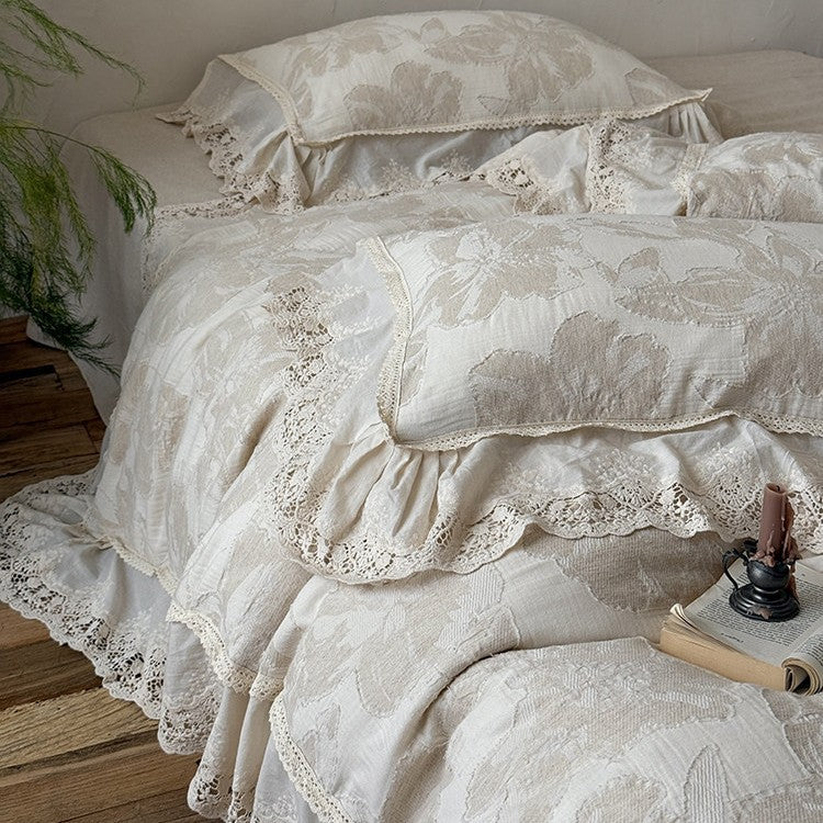 Vintage-inspired cotton-linen bedding set with large floral pattern, ruffle, and lace appliqué