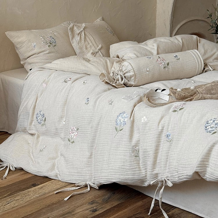 Embroidered cotton-linen bedding set with decorative ribbons and fine floral design