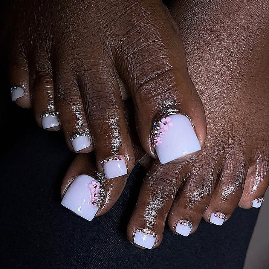 Nail art set with elegant glitter embellishments and floral accents Stornfield