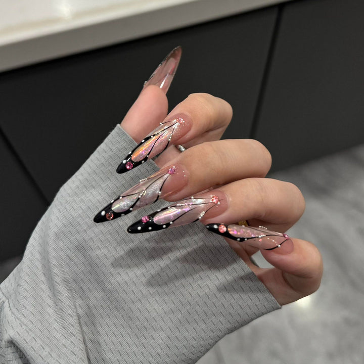 Artifical nail tips with elegant designs and glitter accents Stornfield