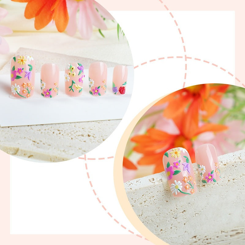 Acrylic nail set with floral motifs and glitter accents Stornfield