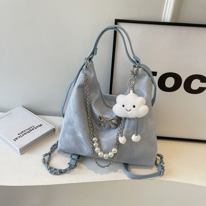 Fashionable handbag with unique pendant and chain accents Stornfield