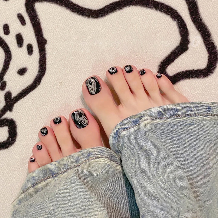 Artistic toenail art with rhinestone and glitter elements Stornfield