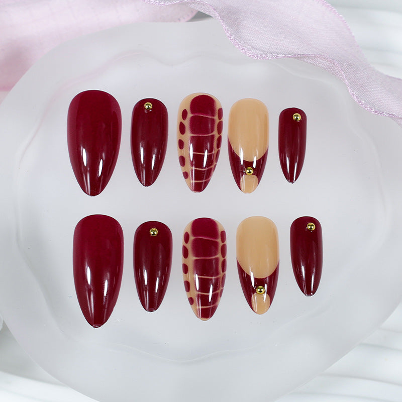 Acrylic nail set with elegant golden accents and trendy design Stornfield