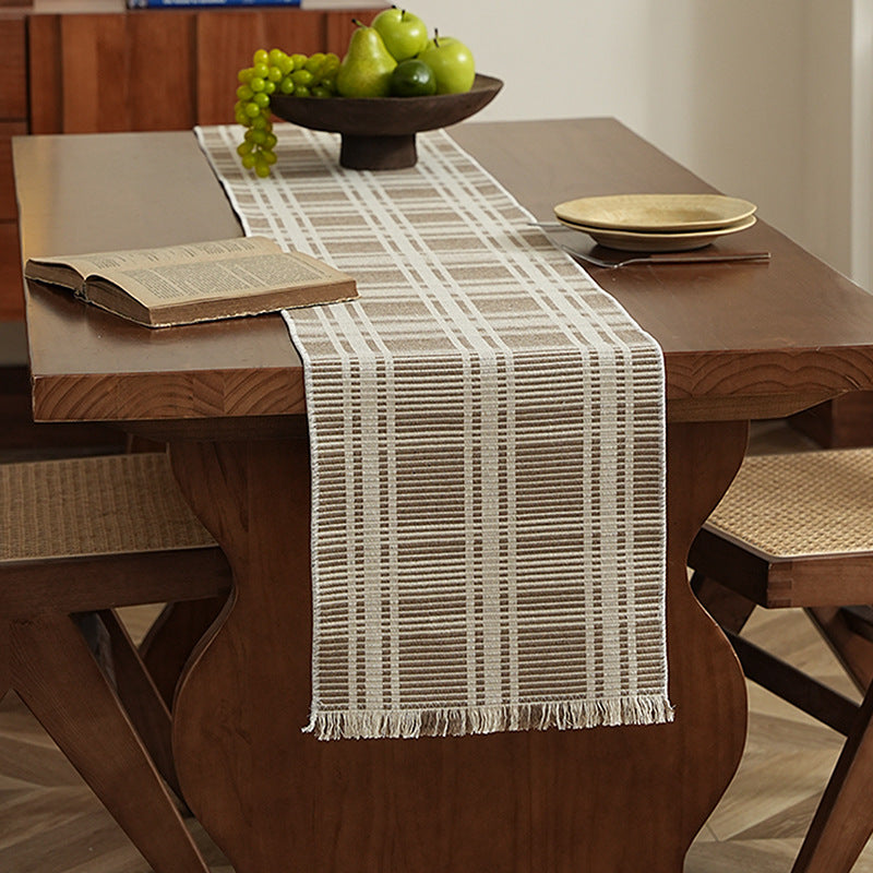 Woven table runner with contrasting center stripe, textured waffle look and decorative fringes