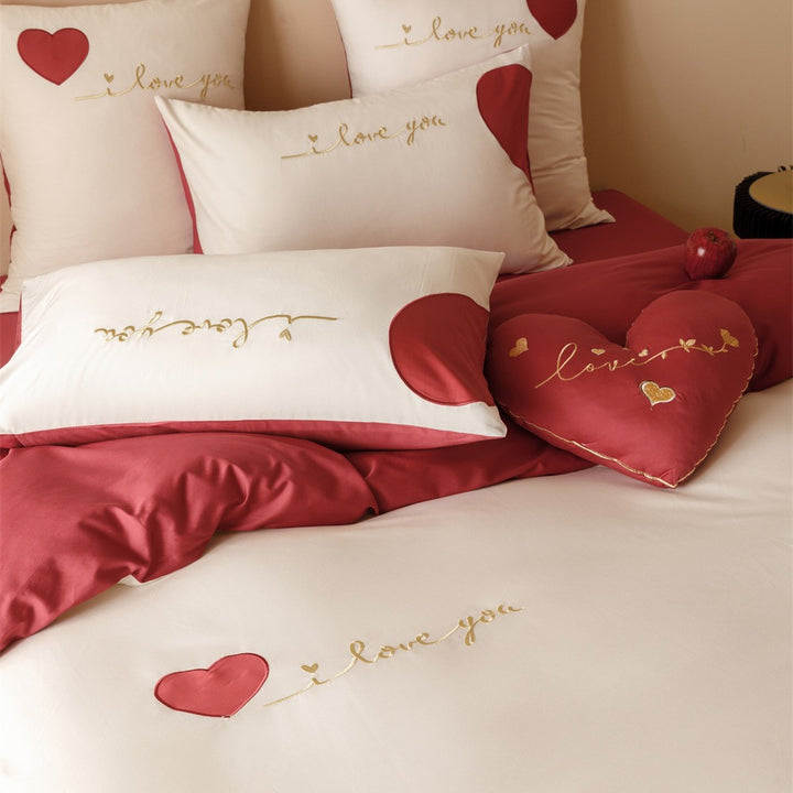 Romantic bedding set made of cotton satin with appliquéd hearts and golden embroidery
