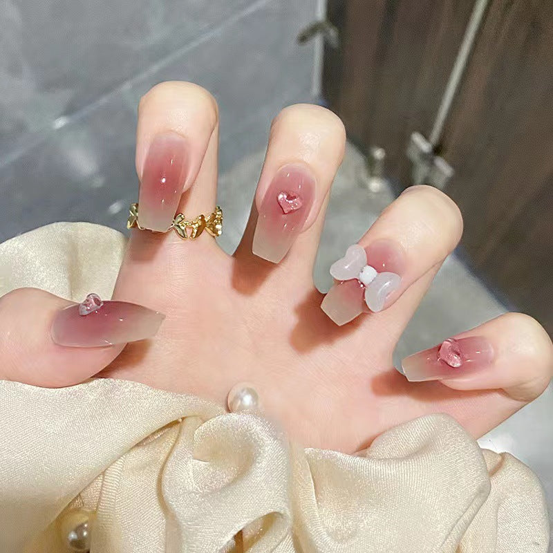 Artful acrylic nails with heart and bow design Stornfield