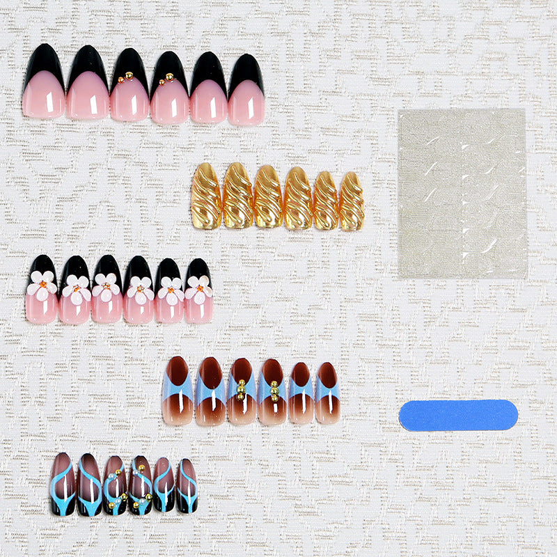 Artificial nail set with filigree floral decorations and glamorous accents Stornfield