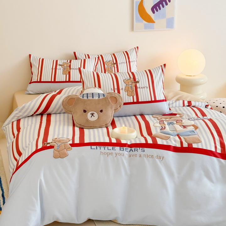 Children's bedding set with embroidered comic design and striped details