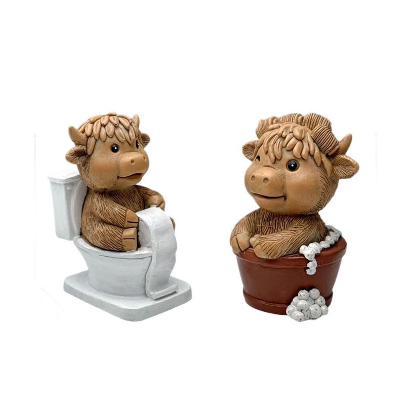Funny decorative figure of a Highland cow on toilet Stornfield