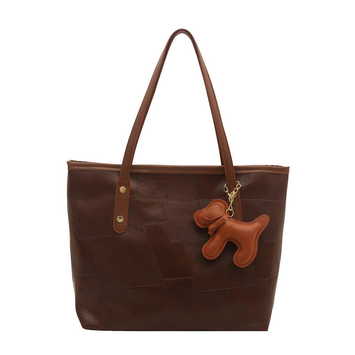 Stylish Textured Tote Bag with Decorative Charm