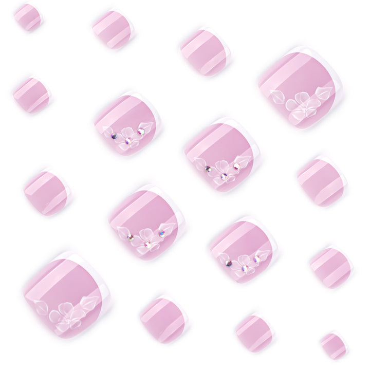 Artful toenail design with delicate flowers and glitter embellishment Stornfield